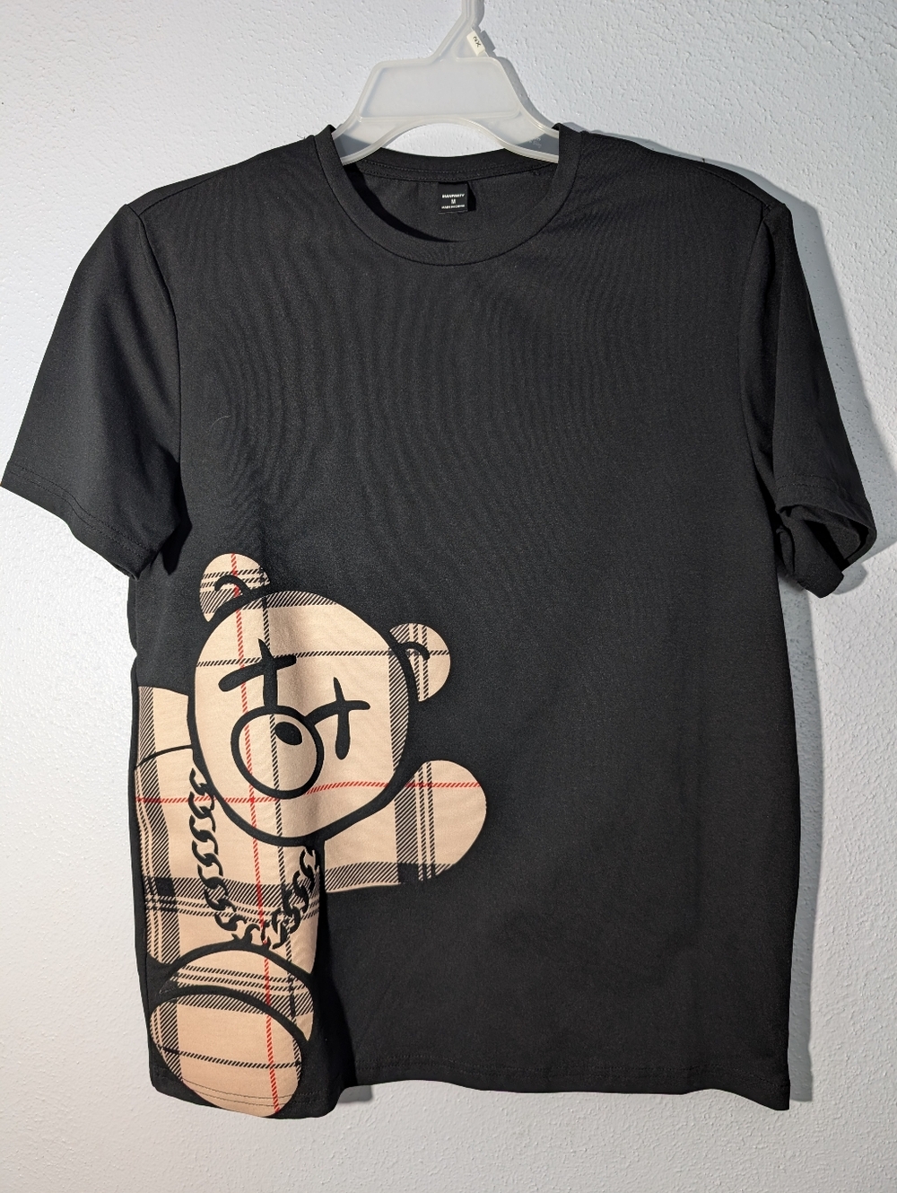 Manfinity Black Tee with Beige Plaid Teddy Graphic